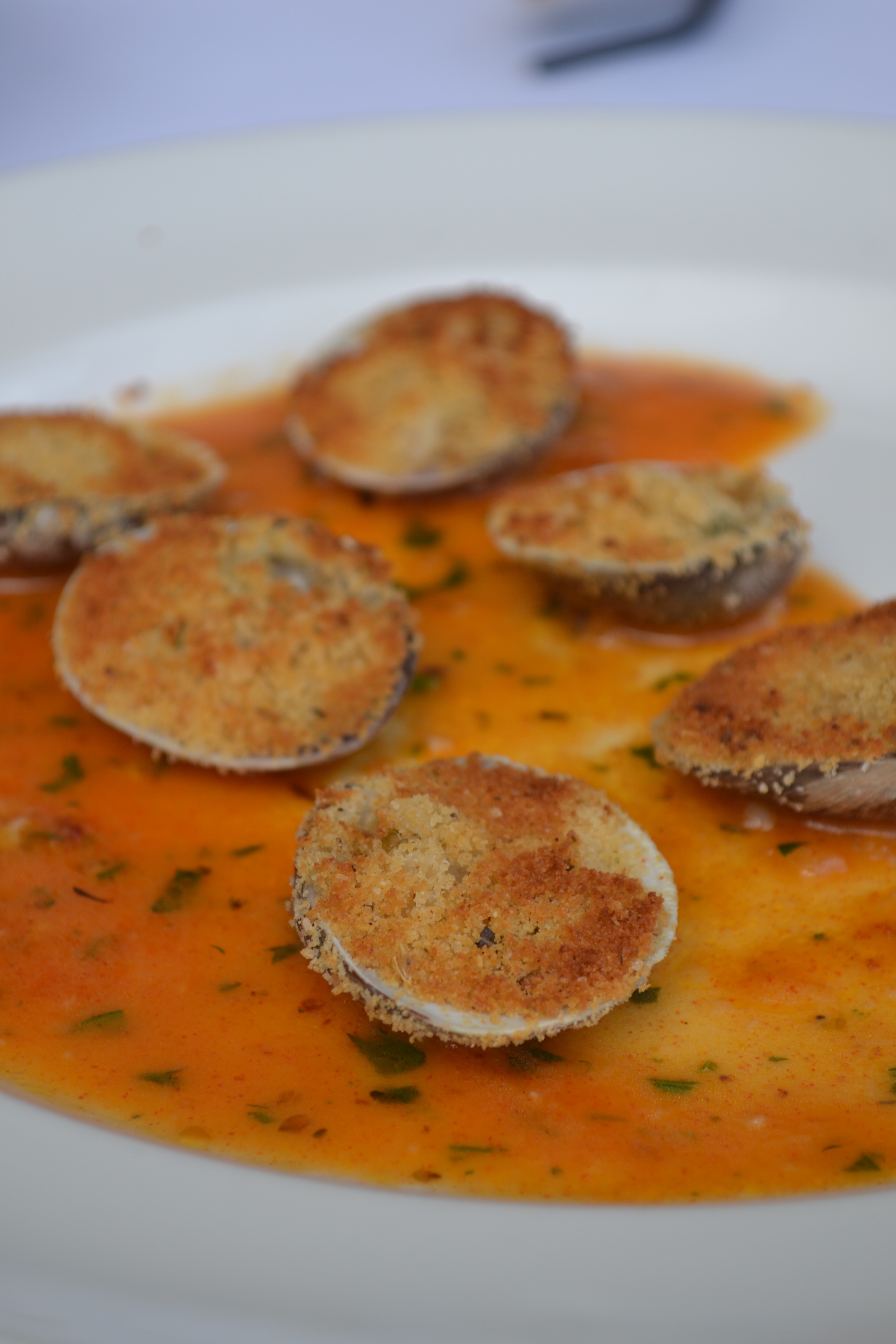 Vongole Oreganata at Il Mulino New York Miami -  Clams on the half shell, baked with bread crumbs, fresh herbs, garlic, white wine, and lemon.