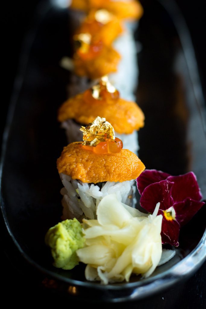 Sushi with Uni topping and edible gold flake at FUJI Boston