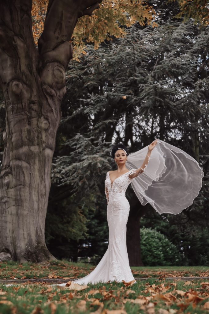 Barbra Streisand Wedding Dress from Dando London Legends Bridal Collection.  Beaded motifs on all-over tulle fishtail gown with plunging V-neckline & long illusion sleeves.