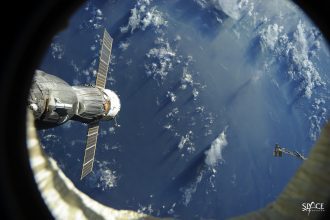 Earth and the Soyuz spacecraft docked to the International Space Station.