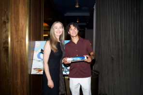 From Left to Right: Annemie Fourie, Evan Sharma stand side-by-side at event showcasing Kor waterbottles and Evan's art.