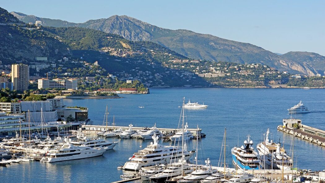 Monaco harbor with yachts and city buildings in the background