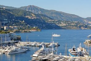 Monaco harbor with yachts and city buildings in the background