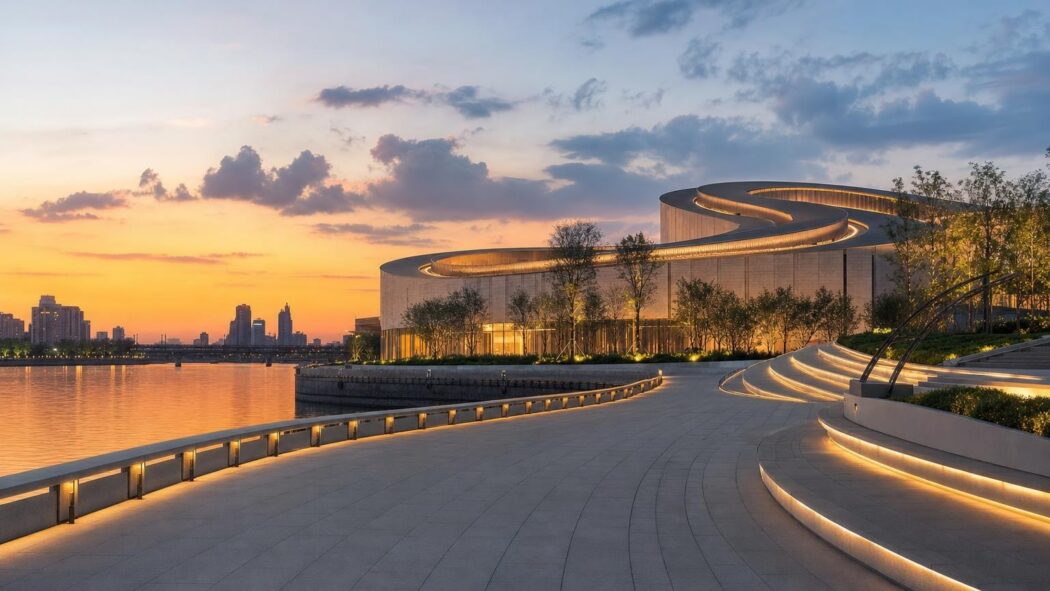 Shanghai Grand Opera House with spiraling rooftop beside the Huangpu River at sunset