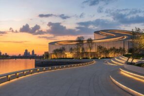 Shanghai Grand Opera House with spiraling rooftop beside the Huangpu River at sunset