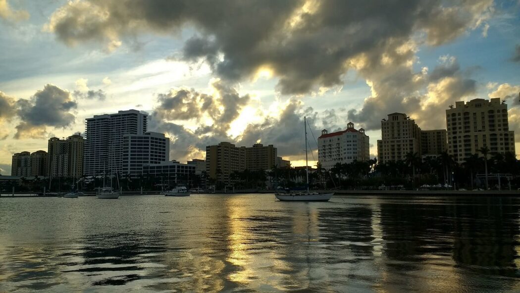West Palm Beach city skyline at sunset with boats on the water