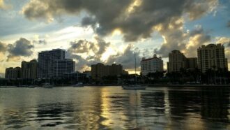 West Palm Beach city skyline at sunset with boats on the water