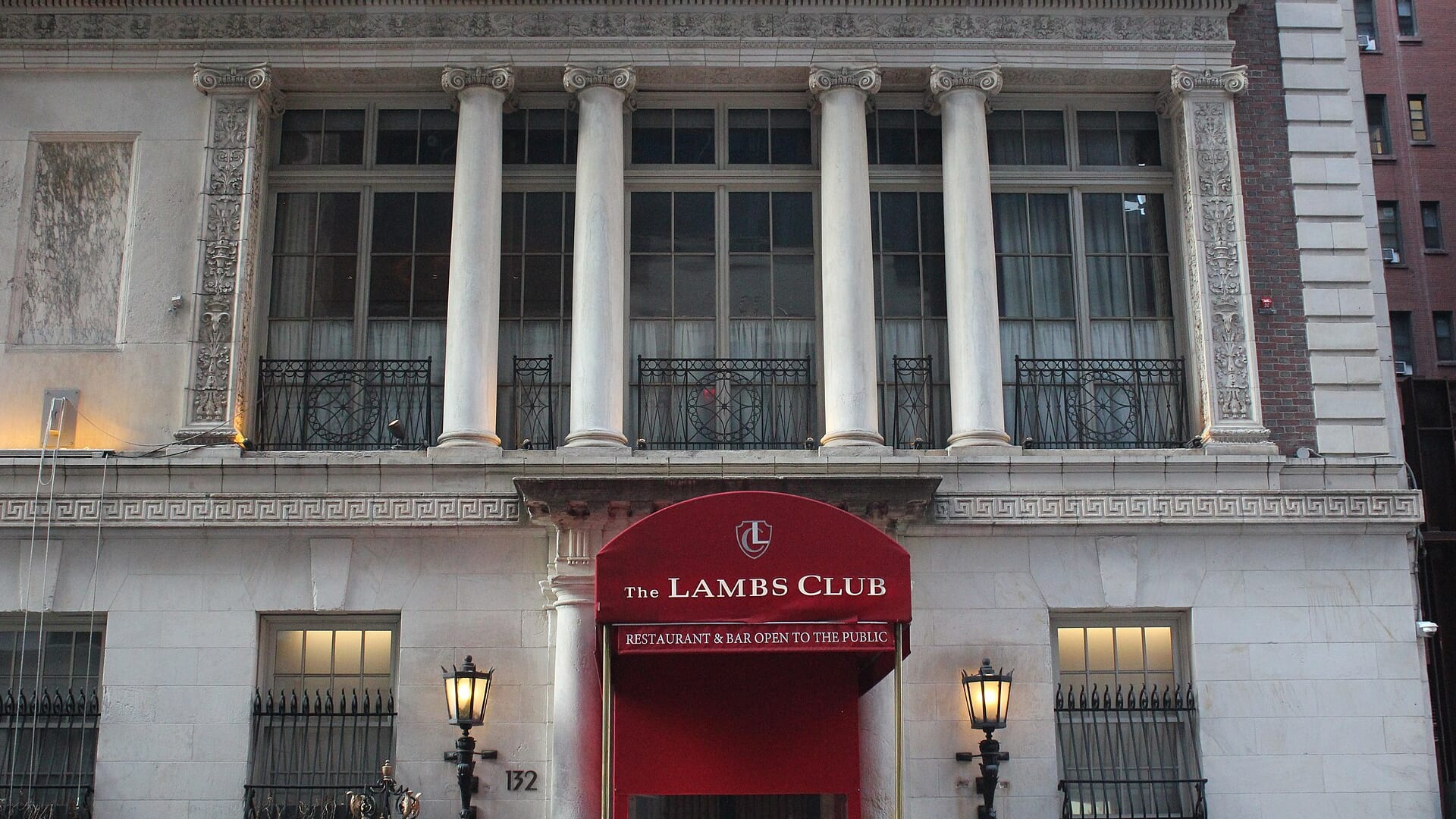 The Lambs Club facade with red awning at 130 West 44th Street