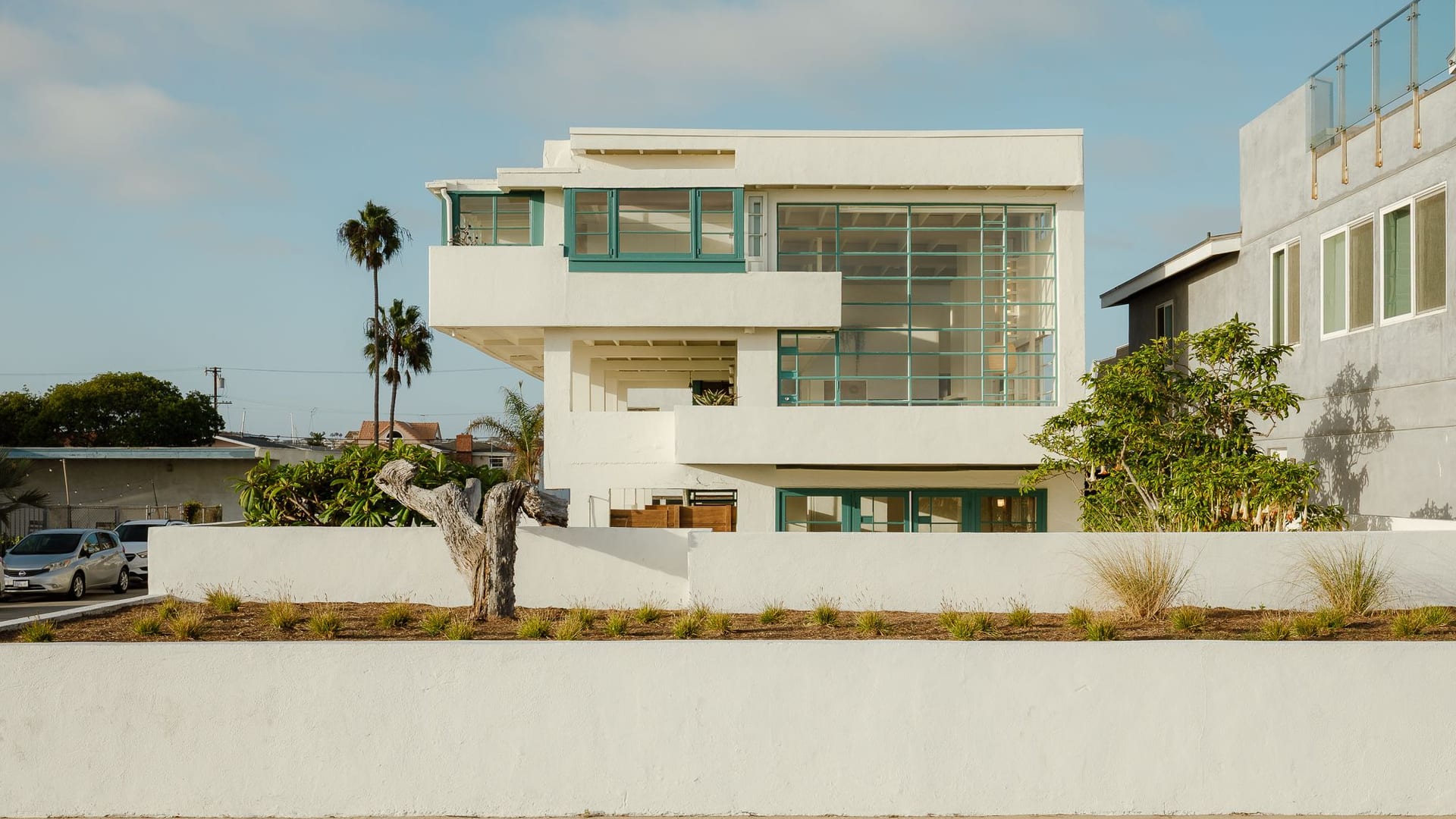 The ocean side of Lovell Beach House with large windows and landscaping