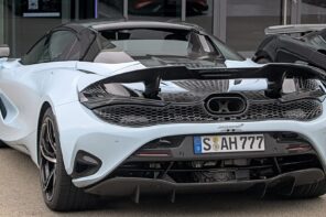 McLaren 750S Spider in light blue parked outside a glass building