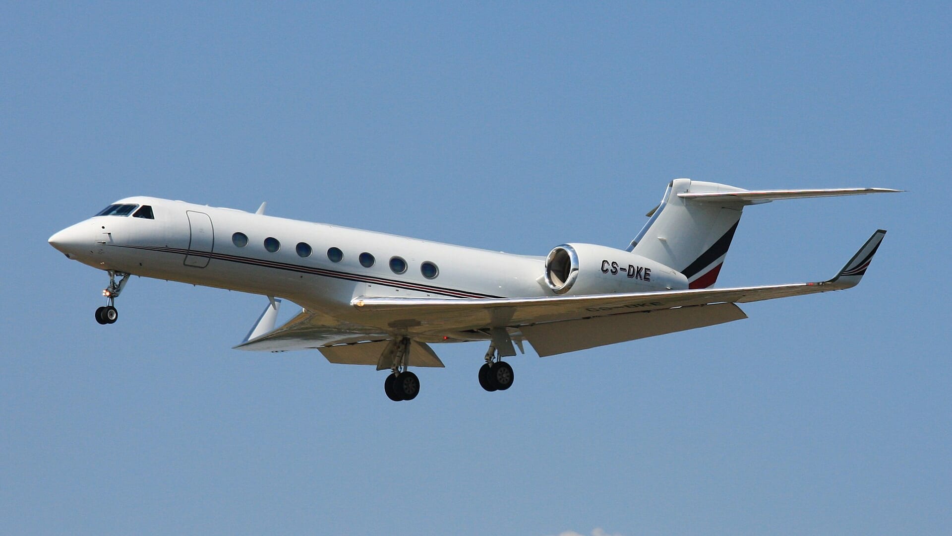 NetJets Gulfstream G550 private jet landing with landing gear down